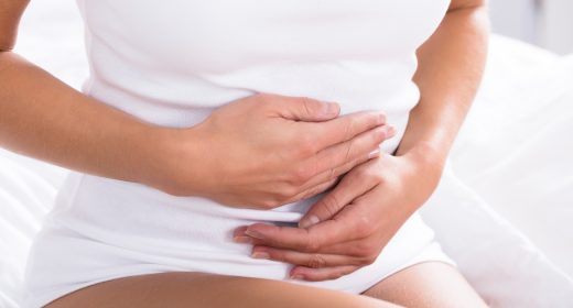 Close-up Of A Woman Suffering From Stomach Pain